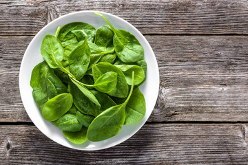 Fresh vegetables, green spinach on plate, vegetarian food and healthy eating concept