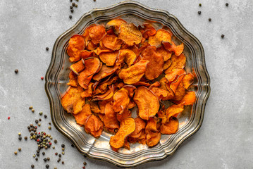 Baked potato chips with sweet potatoes, dish on plate, vegan food and healthy diet concept