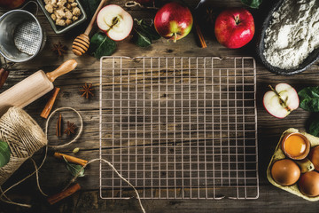 Autumn cooking background, Apple pie baking concept, fresh red apples, sweet spices, sugar, flour, rolling pin, eggs, baking utensils, wooden background copy space