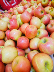 Red apples on the counter in the supermarket.