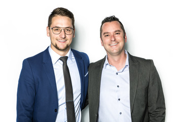 Two Handsome car salesmen on white background