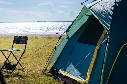 Camping green tent near lake