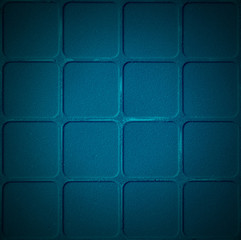 Old scratched and chapped painted dark blue wall with blocks.