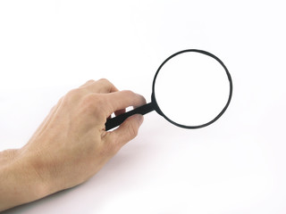 close up. magnifying glass in hand businessman.photo with copy s