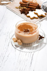 cup of hot spicy masala tea and Christmas cookies on white background, vertical