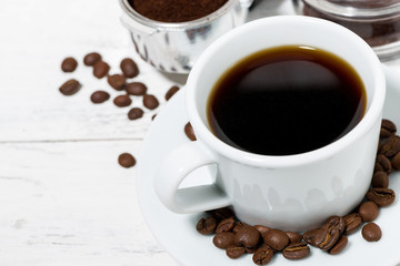 cup of freshly brewed black coffee on a white table