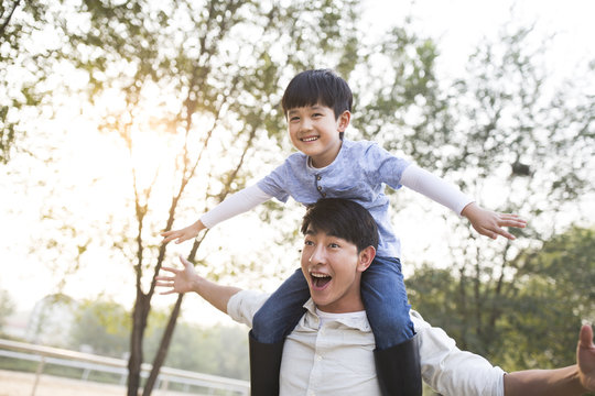 Cheerful father and son enjoying park