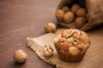 Tasty homemade walnut muffins on table. Sweet pastries