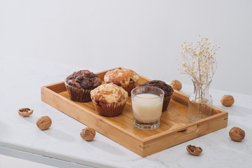 Breakfast with fresh homemade delicious muffins and milk.