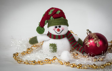 cute toy snowman and various Christmas decorations on a white b