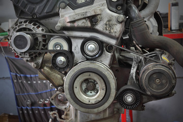 Pk belt, pulleys and alternator at modern car engine after servicing