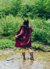 Woman with raincoat in a forest