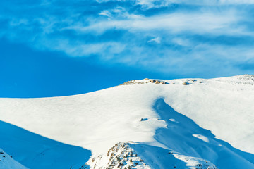 Snowy winter mountains with softwood forest