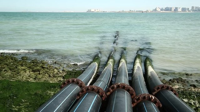 Pipes for intake of sea water and desalination in Doha, Qatar. Desalinization of sea water for city needs, water intake from Persian Gulf, Arabian Peninsula