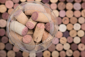 Wine cork stoppers in glass Natural background Top view Vertical Close up Selective Focus