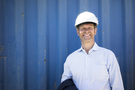 Portrait of smiling man wearing shirt and hard hat