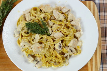 Macaroni of Carbonara with smoked sausage, bacon, sauce. Tasty lunch in the Italian restaurant with herbs, dill