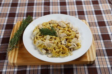 Macaroni of Carbonara with smoked sausage, bacon, sauce. Tasty lunch in the Italian restaurant with herbs, dill