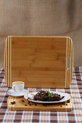 two pieces of chocolate cake, cake and a cup of coffee with cream