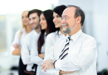 adult confident businessman on background of business team