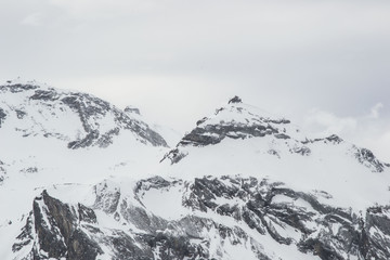 Obraz premium some time spent in switzerland alps while skiing, mostly cloudy weather, but beautiful landscape view of mountain peaks