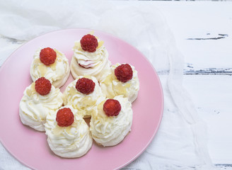 cakes made of egg white and whipped white cream with raspberries