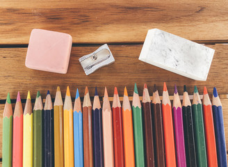 Fototapeta premium colored pencil eraser sharpener on blackboard