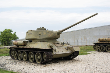 Old aged soviet tank from second world war - Armored fighting vehicle with cannon is parking. 