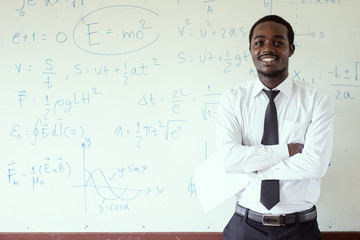 African foreign teacher teaching  science in the classroom.