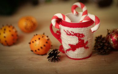 Christmas Cup and oranges on wooden background blurred.