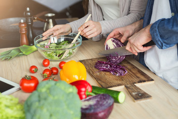 Closeup of couple cooking healthy food together