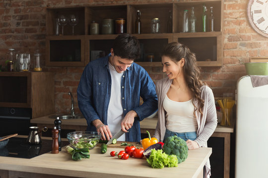 Happy couple cooking healthy food together