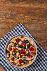 Breakfast, muesli with milk and fresh fruit.