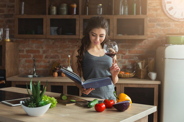 Happy woman preparing healthy food in kitchen