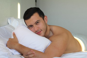 Fototapeta na wymiar Handsome ethnic man shirtless in bed