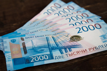 russian banknotes of 2000 rubles on wooden background