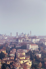 Aerial view of Bergamo in a foggy day, Italy.