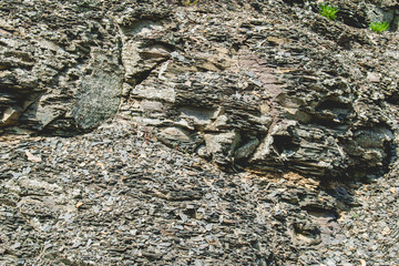 A hard and coarse natural background made of stones of gray shades. 