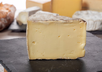 piece of french cheese on a slate plate
