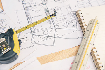 Concept architects, equipment architects On the desk with a plan and blueprint in the office. Architect rolls and plans.