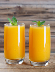 Healthy pumpkin fruit smoothie with  mint leaves on  table.
