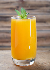 Healthy pumpkin fruit smoothie with  mint leaves on  table.