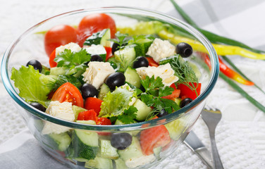 Salad of fresh vegetables and cheese on  served table