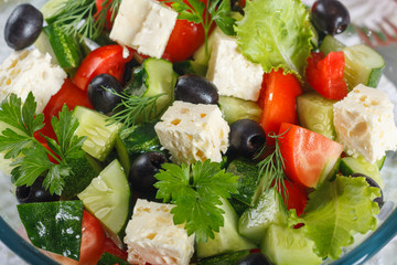 Salad of fresh vegetables and cheese on  served table