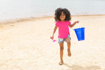 Portrait of smiling girl having fun on beach 