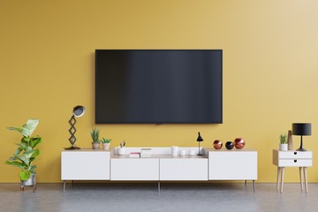 TV on cabinet in modern living room with yellow wall background,3d rendering