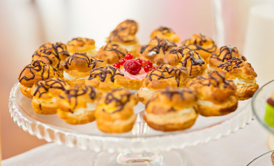 Small creamy cakes with chocolate topping