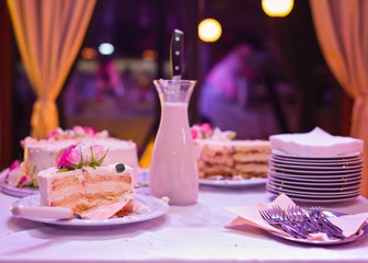 A slice of a creamy wedding cake with real flower rose decoration
