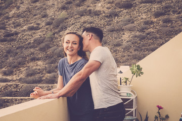 nice young couple caucasian in love together flirt and enjoy romantic time together on the terrace with mountain natural backgorund. happiness and relationship concept