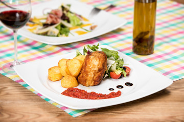 Breaded chicken fillet with fresh vegetables
